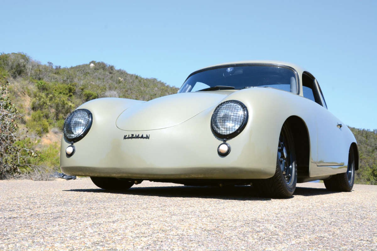 Vintage Porsche car on a road with a scenic background