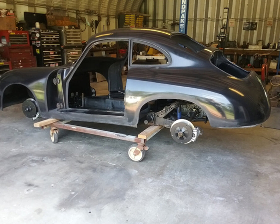 Car body on a stand in a workshop setting